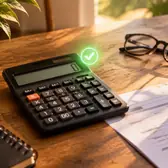 Calculator with a glowing green checkmark, tax form, pen, glasses and coffee on a wooden table in morning light